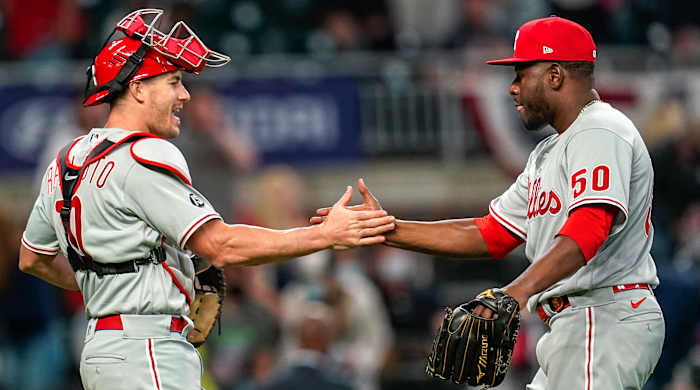 Phillies relief pitcher Héctor Neris celebrates with catcher J.T. Realmuto after beating the Braves.